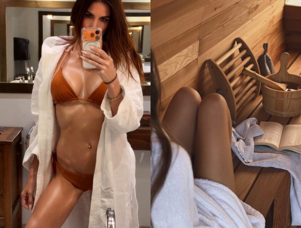 Misha in a brown bikini and white robe takes a mirror selfie in a bathroom; next to her, her legs are seen as she relaxes in a wooden sauna with a towel, a bucket, and an open book.