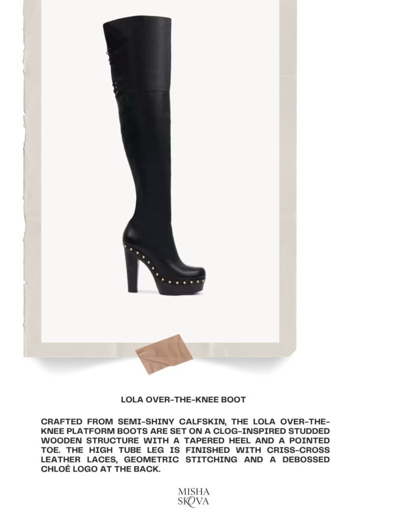 A tall, black, over-the-knee platform boot made of semi-shiny leather with a chunky high heel, pointed toe, decorative studs, and back lacing. Text below describes the boot’s features and brand.
