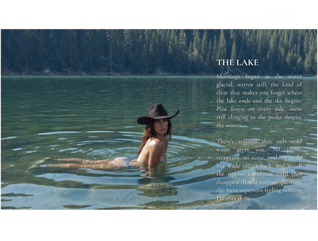 Woman swimming in a clear mountain lake surrounded by pine trees